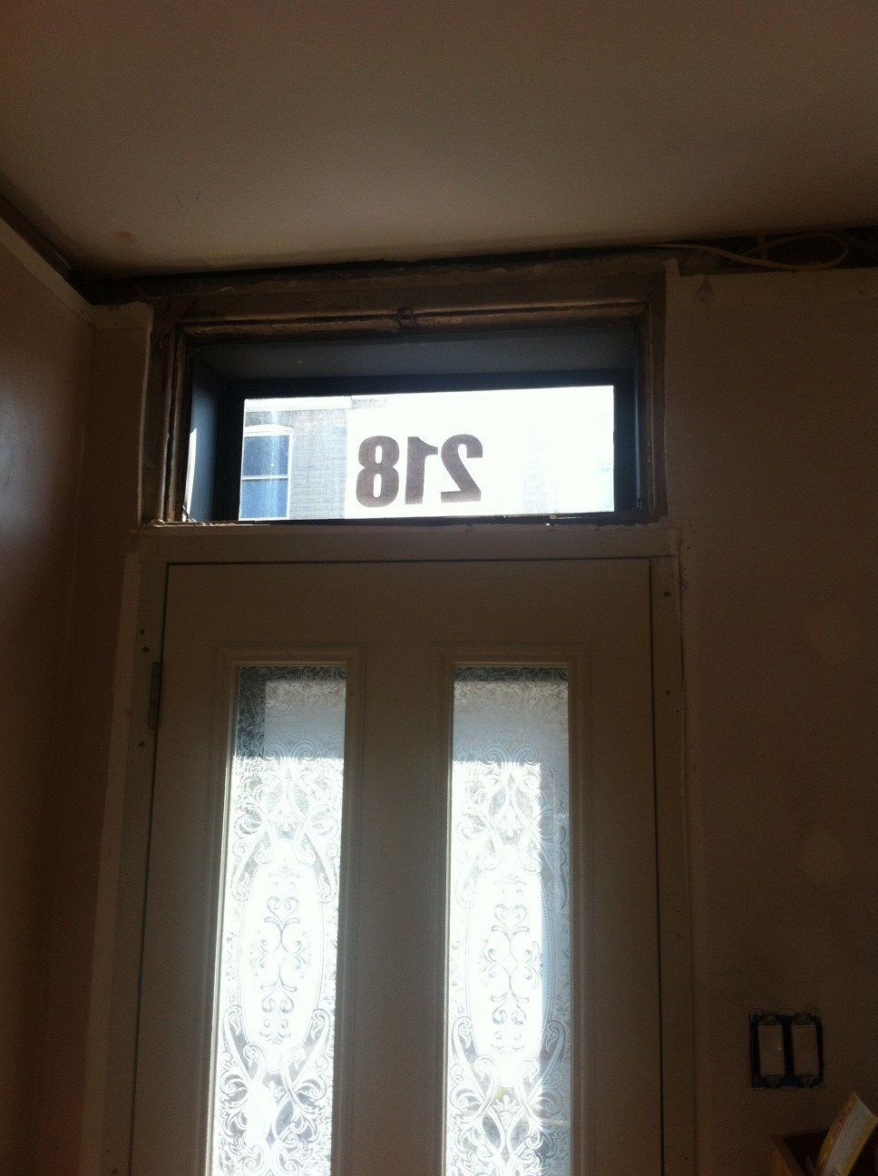 Transom window above front door. Temporary number added so people can find us.