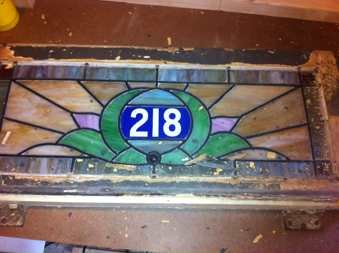 Our house number in stained glass removed from the front door tansom for restoration.